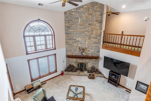 carpeted living room with ceiling fan, high vaulted ceiling, and a fireplace