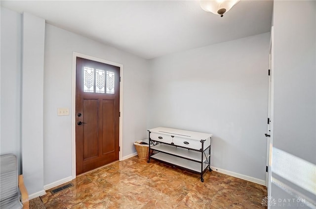 foyer entrance featuring visible vents and baseboards