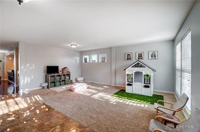 interior space with carpet flooring and baseboards