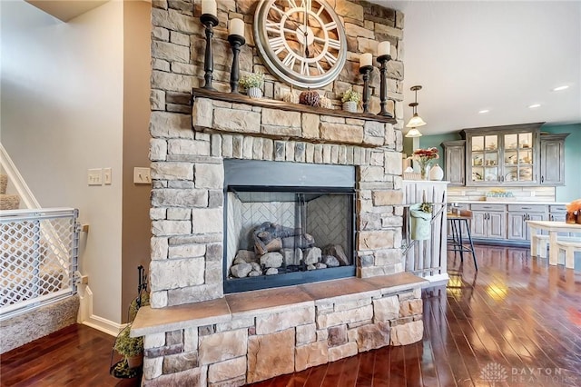 details with a fireplace, recessed lighting, and wood finished floors