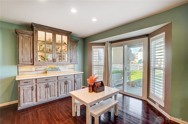 dining area featuring a healthy amount of sunlight and dark hardwood / wood-style flooring