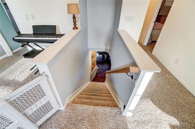 staircase with baseboards and carpet