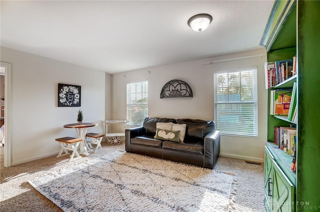 carpeted living room featuring baseboards