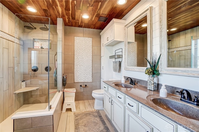 bathroom with hardwood / wood-style flooring, toilet, vanity, tile walls, and an enclosed shower