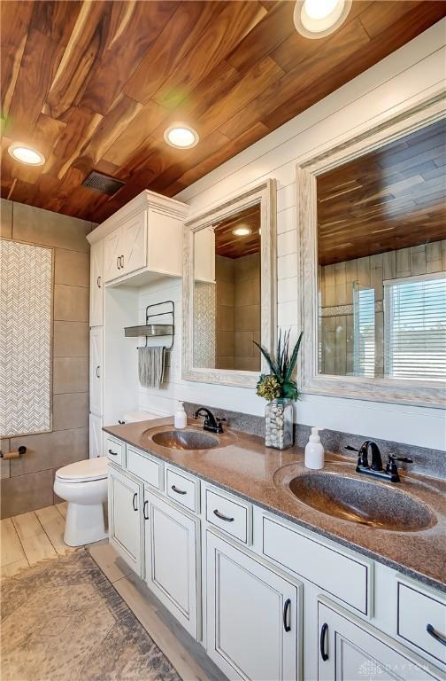 bathroom featuring vanity, toilet, and wooden ceiling