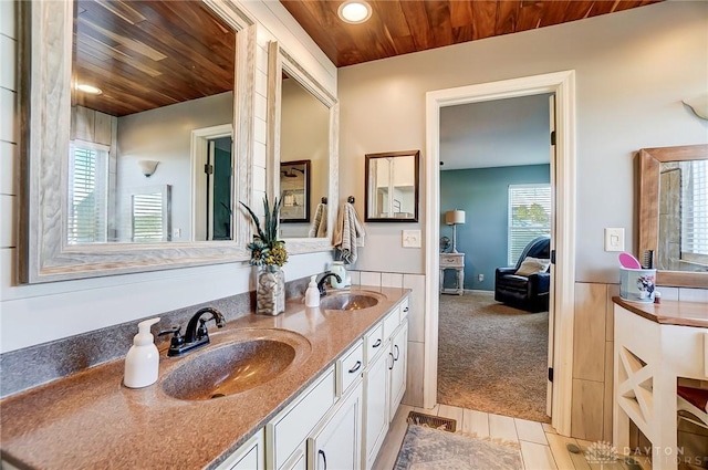 full bathroom featuring double vanity, recessed lighting, wooden ceiling, and a sink