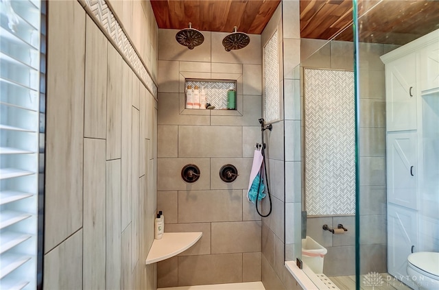 bathroom with toilet, wooden ceiling, and tiled shower