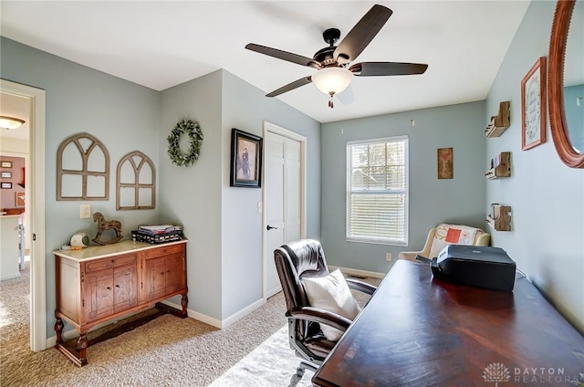 office area featuring baseboards, light colored carpet, and ceiling fan