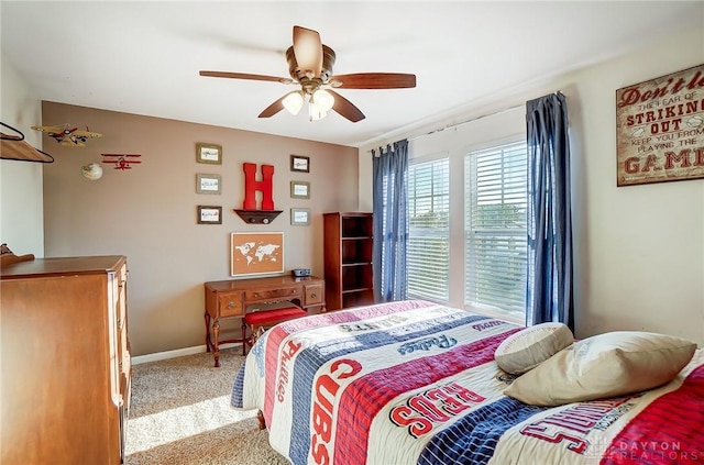 carpeted bedroom featuring baseboards and ceiling fan