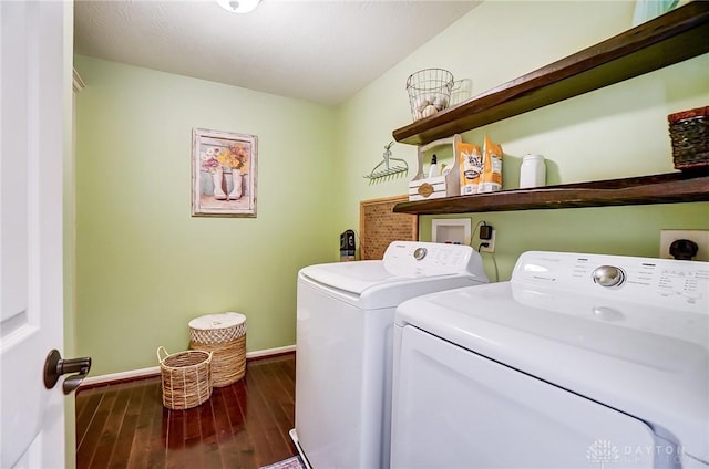 laundry room featuring washer and dryer, laundry area, dark wood finished floors, and baseboards