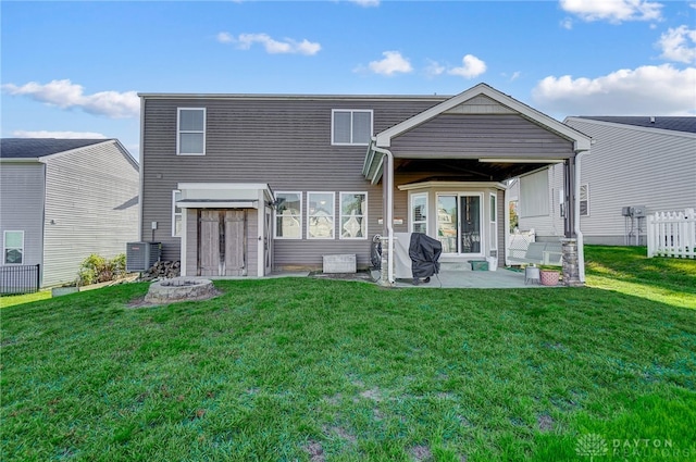 back of house featuring a yard, cooling unit, and a patio