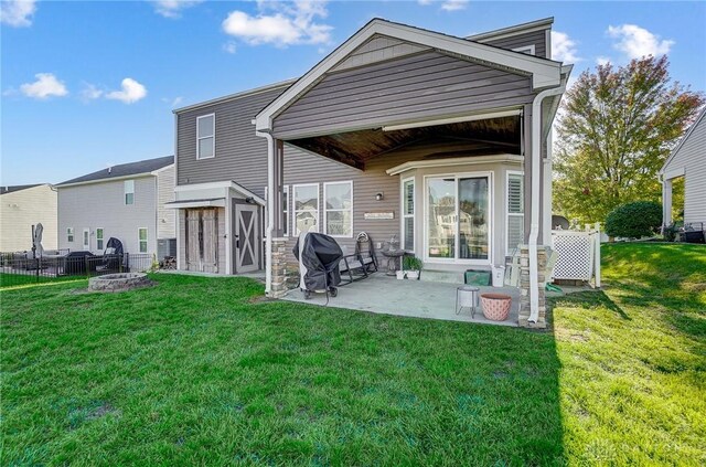 back of house featuring a yard and a patio