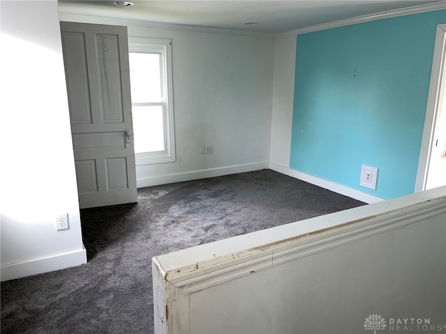 carpeted spare room with crown molding