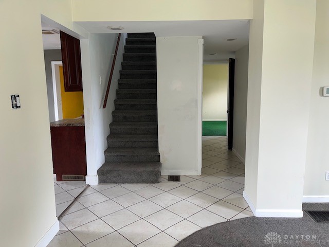 staircase featuring tile patterned floors