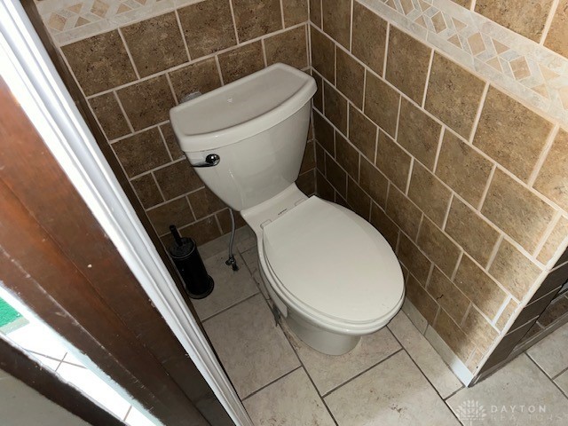 bathroom featuring tile walls, toilet, and tile patterned flooring