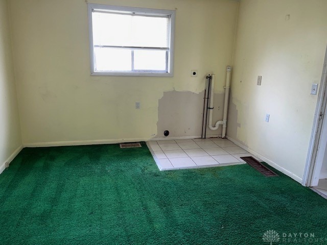 unfurnished room featuring light colored carpet