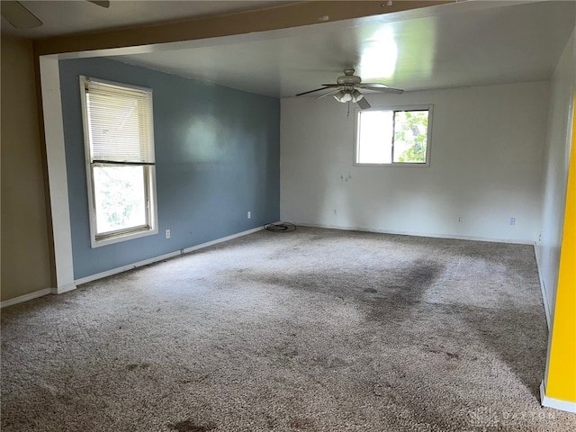 carpeted empty room featuring ceiling fan