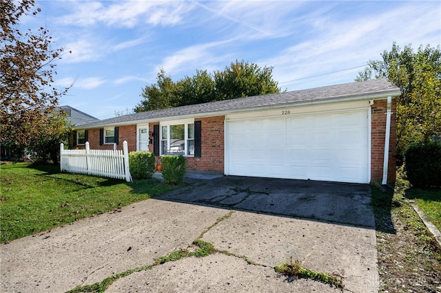 ranch-style home with a front yard and a garage