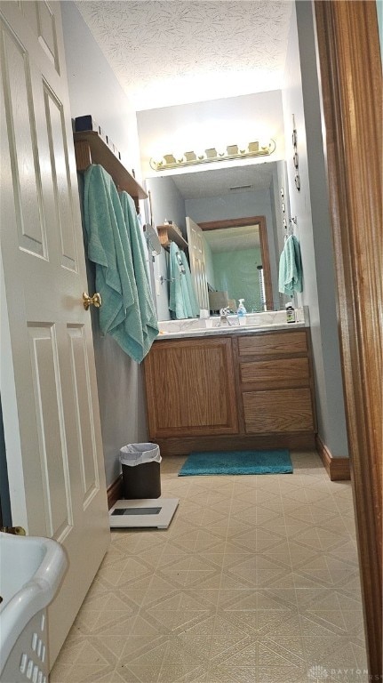 bathroom with vanity and a textured ceiling