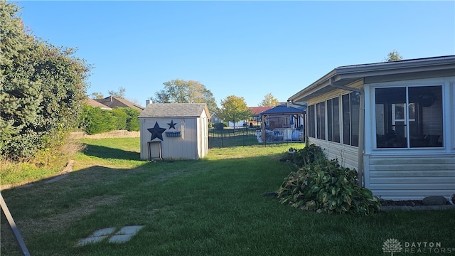 view of yard with a storage shed and a sunroom