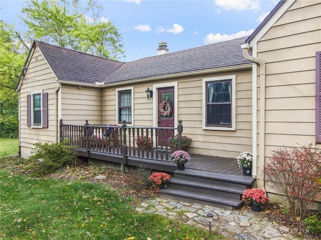 exterior space featuring a shingled roof