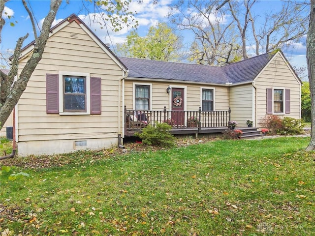 ranch-style home with crawl space, cooling unit, a shingled roof, and a front yard