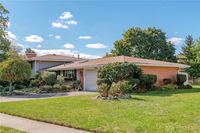 view of front of property featuring a garage and a front lawn