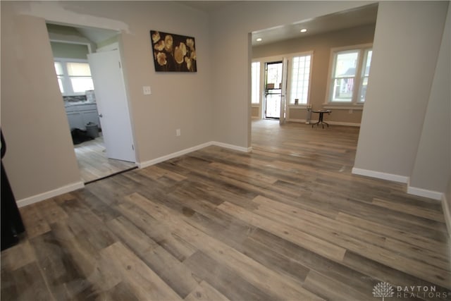 spare room with dark hardwood / wood-style floors and a healthy amount of sunlight