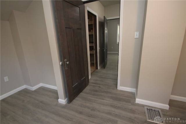 hallway with hardwood / wood-style flooring