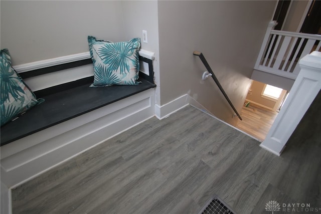 stairs featuring hardwood / wood-style floors