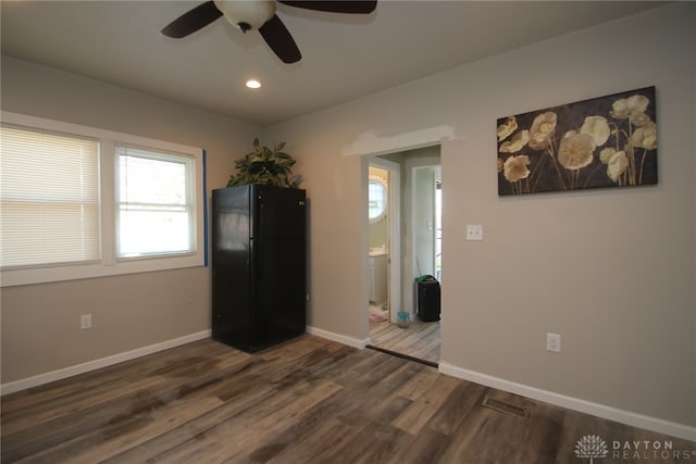 interior space with ceiling fan and dark hardwood / wood-style floors