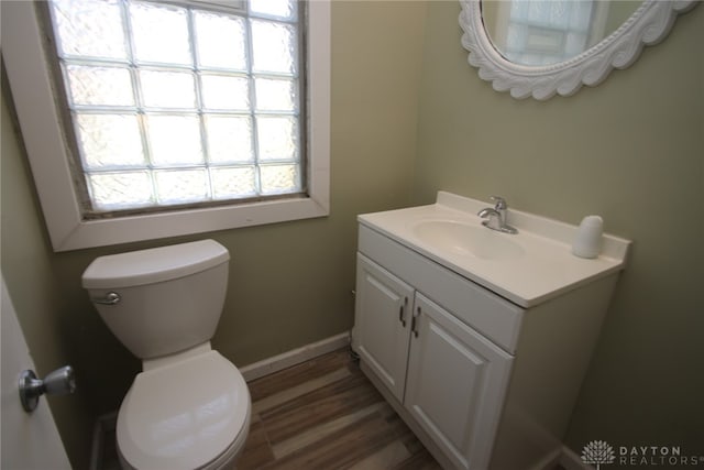 bathroom featuring vanity, hardwood / wood-style flooring, and toilet