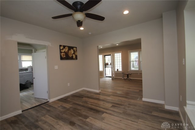 unfurnished room featuring dark wood-type flooring and ceiling fan