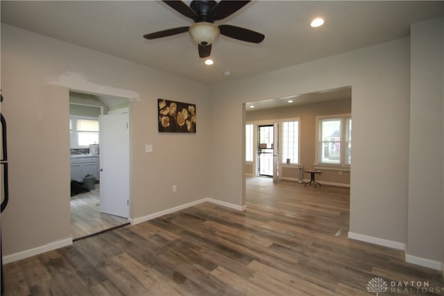 spare room featuring hardwood / wood-style floors, a healthy amount of sunlight, and ceiling fan