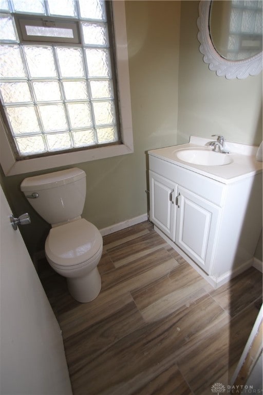 bathroom featuring vanity, hardwood / wood-style flooring, and toilet