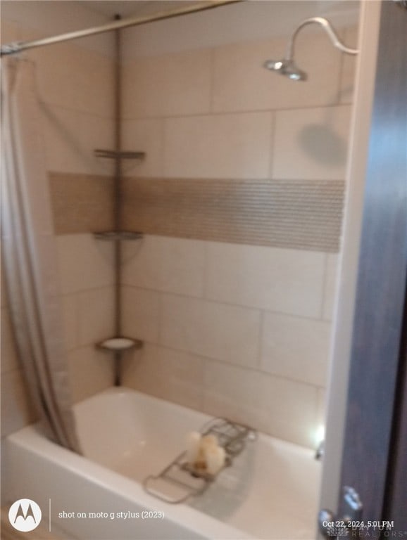 bathroom with shower / tub combo with curtain