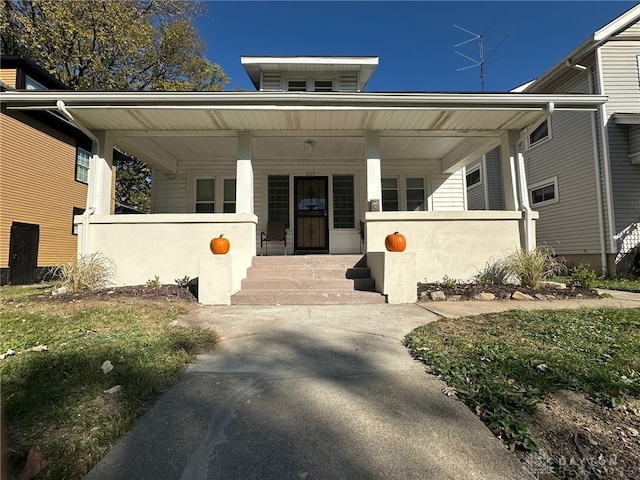 doorway to property featuring covered porch