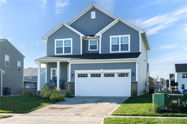 craftsman-style home with a garage, a front yard, and driveway