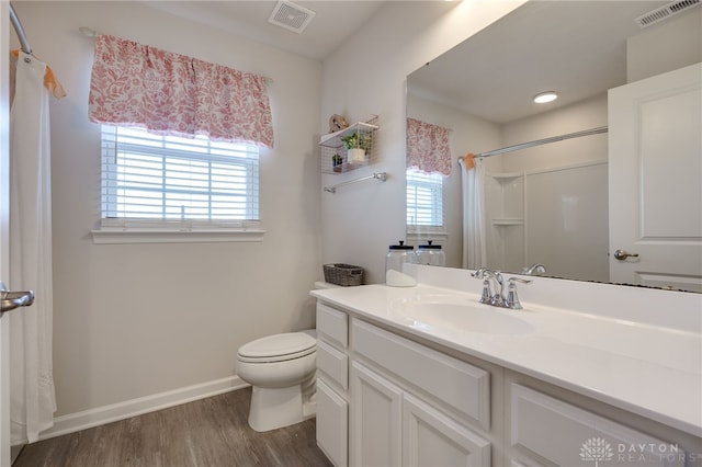 bathroom featuring wood-type flooring, vanity, toilet, and a shower with curtain