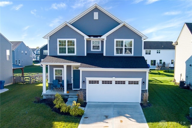 view of front of property with a front yard, a porch, and a garage