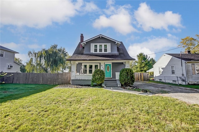 bungalow-style home featuring a front lawn