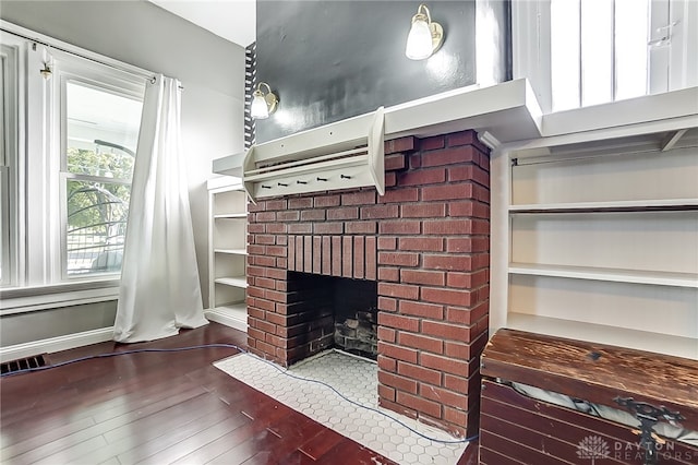 room details with wood-type flooring and a brick fireplace