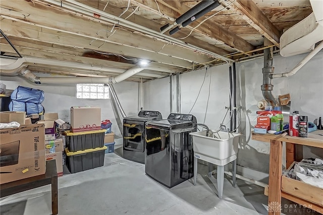 basement featuring separate washer and dryer and sink