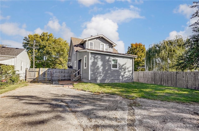 rear view of property featuring a yard