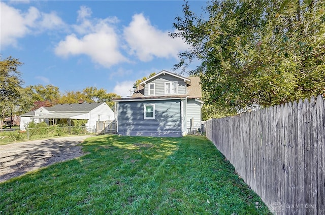 rear view of property with a yard