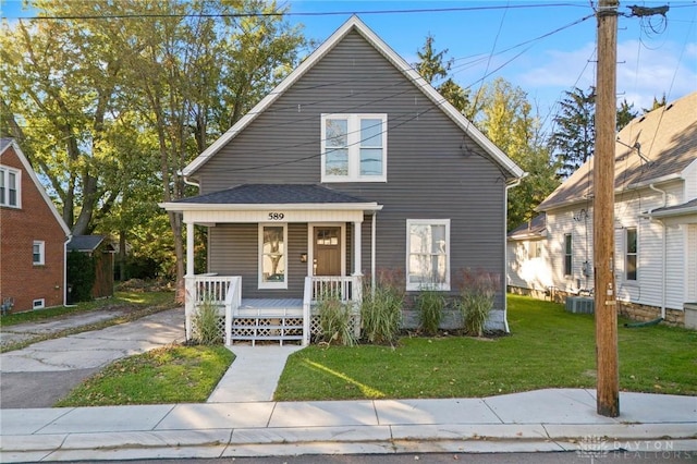 bungalow with a porch and a front lawn