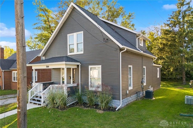 exterior space featuring a porch, central AC unit, and a front lawn