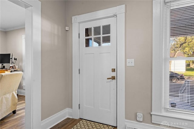 foyer entrance featuring hardwood / wood-style flooring and crown molding