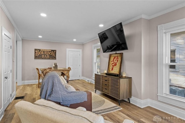 living room featuring light wood-type flooring and ornamental molding