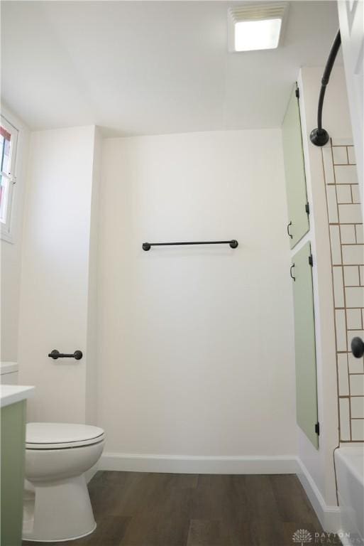 full bathroom featuring shower / washtub combination, hardwood / wood-style floors, vanity, and toilet